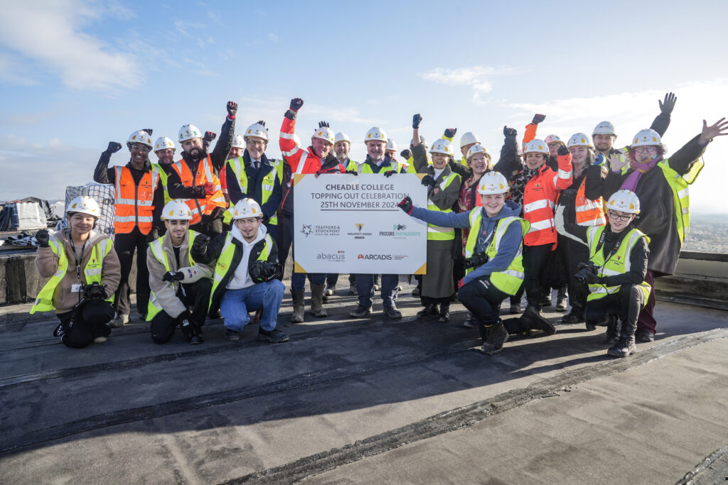 Picture shows: Students and staff from Cheadle College with the Willmott Dixon team celebrating the topping-out milestone at the new campus site.