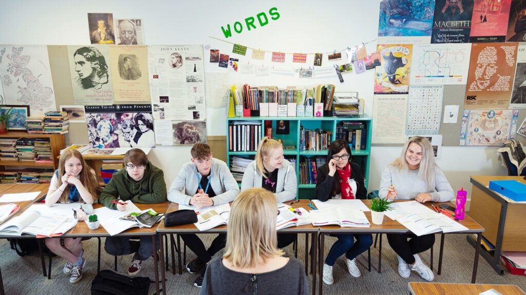 students sat at desk in english classroom