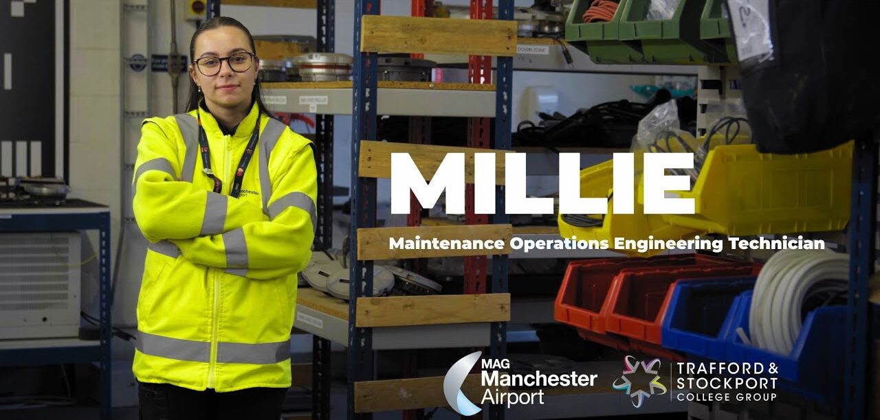 Millie the Apprentice in her hi vis in a workshop